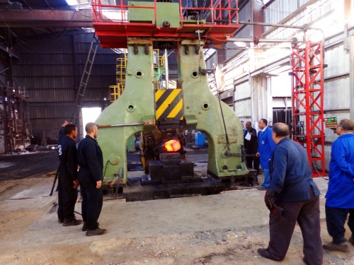 Workers are forging parts with arch free forging electro-hydraulic hammer