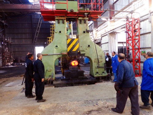 Workers are forging parts with arch free forging electro-hydraulic hammer